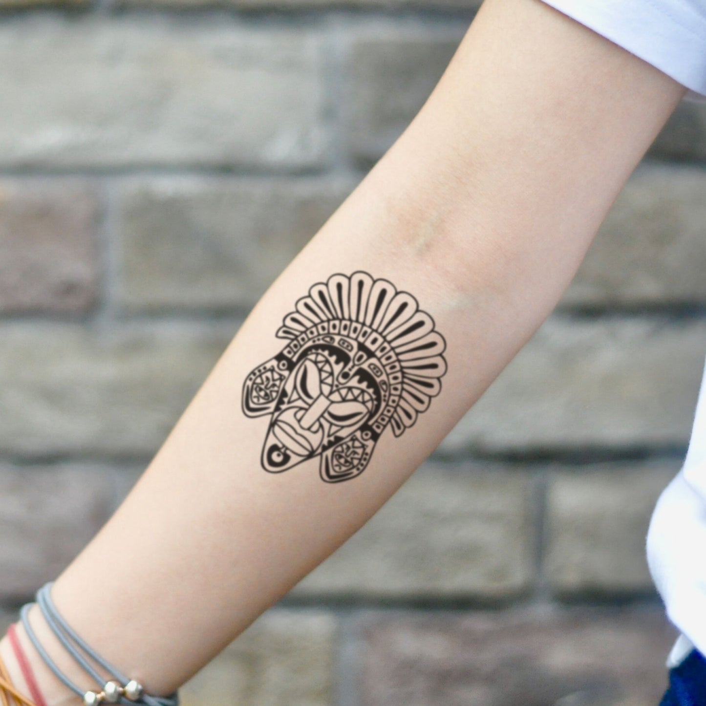 fake small african mask tribal temporary tattoo sticker design idea on inner arm