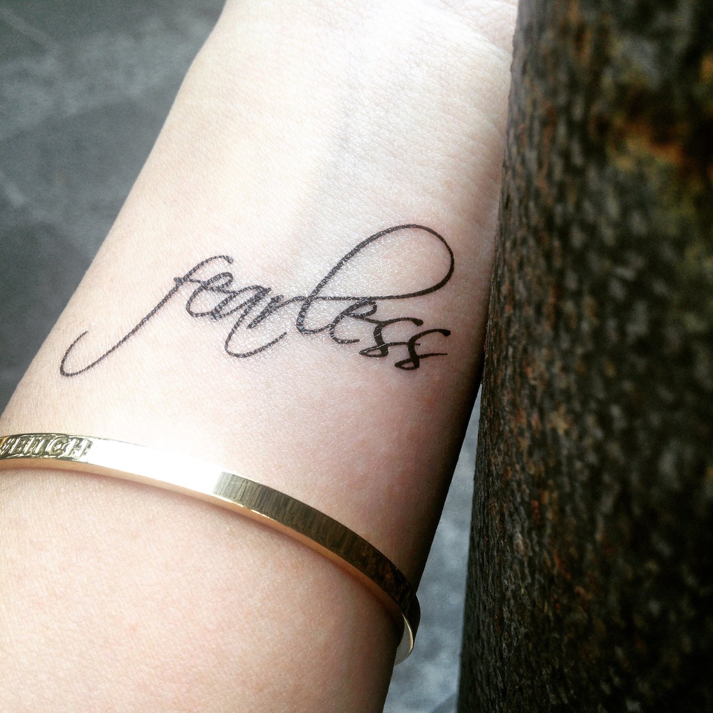 fake small fearless encouraging lettering temporary tattoo sticker design idea on wrist