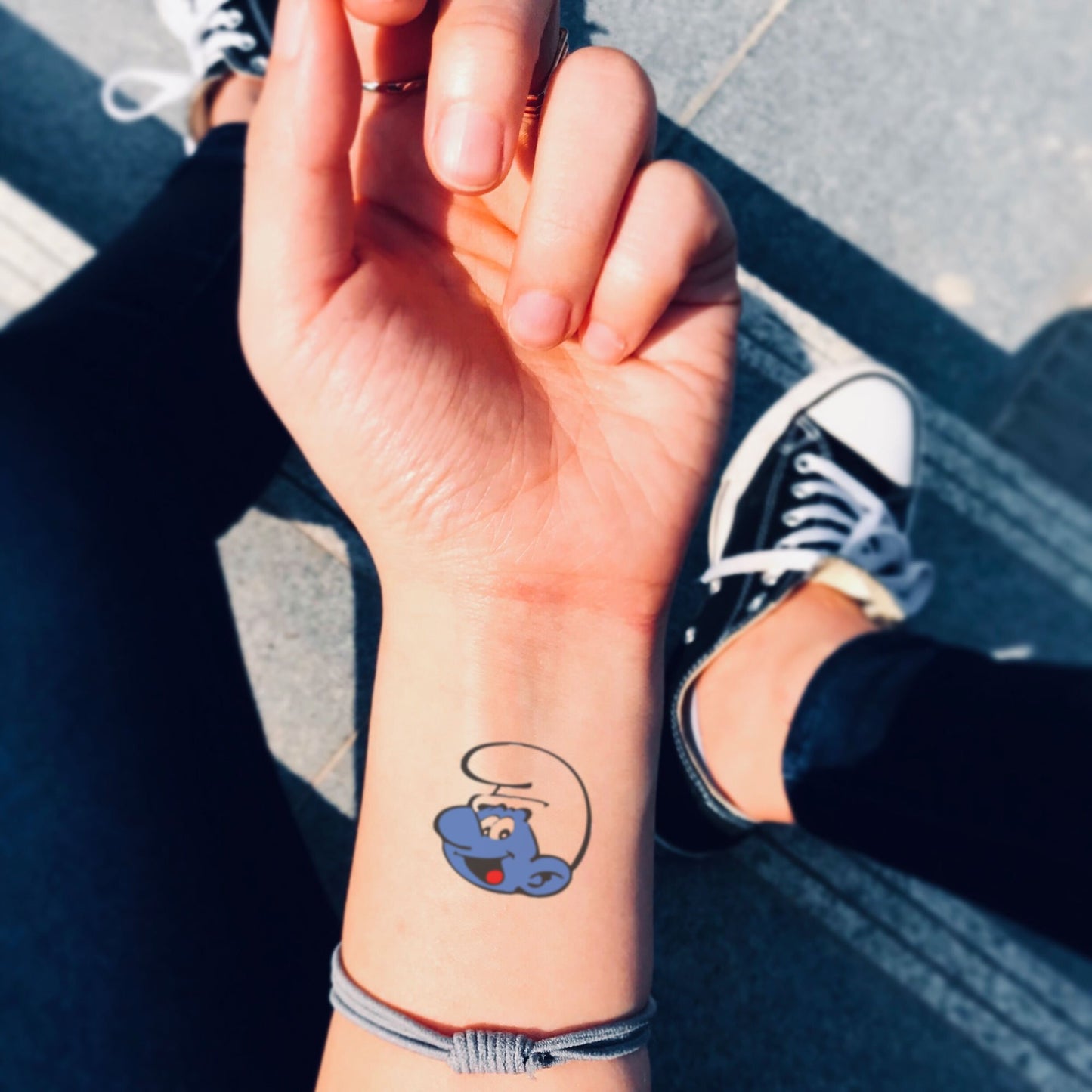 fake small smurf cartoon temporary tattoo sticker design idea on wrist